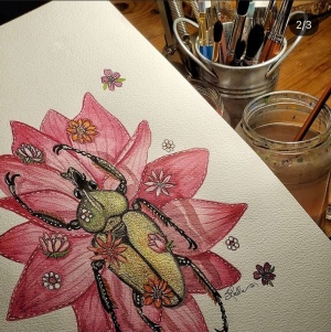 Watercolor of a beetle atop a flower